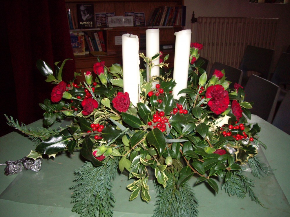 Christmas flowers and candles at Holy Trinity